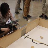 person kneeling in front of a senior project